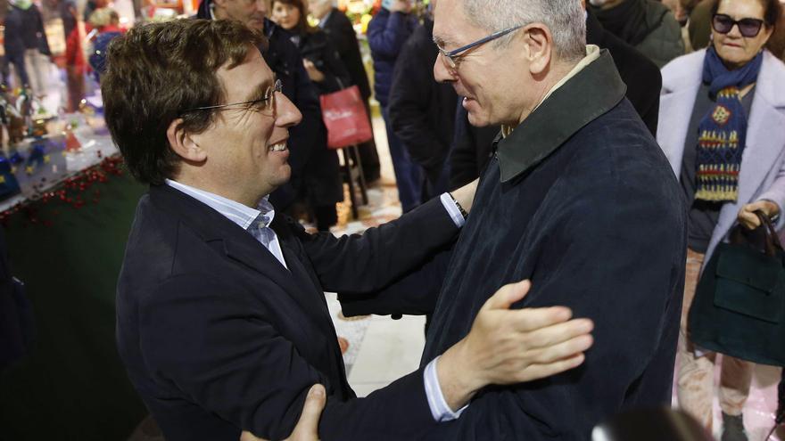 El alcalde Almeida y el exalcalde Gallardón se saludan en el mercado de la Paz de Madrid en diciembre de 2019
